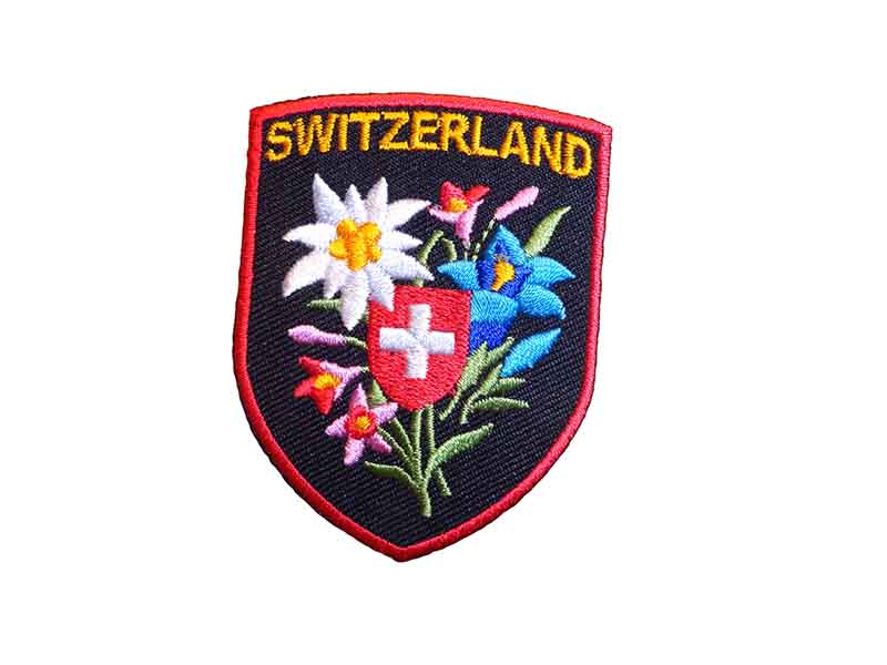 Distintivo in tessuto Stella alpina con croce svizzera